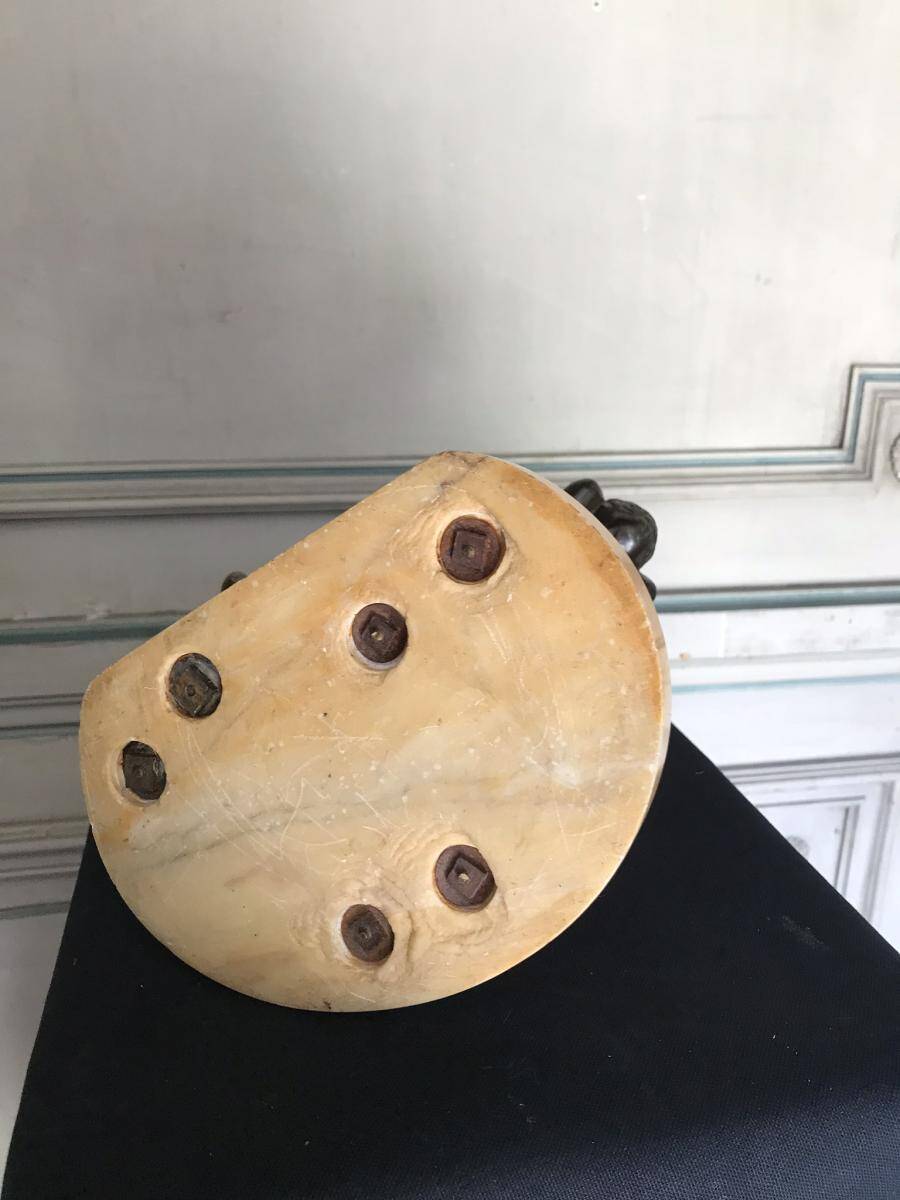 Three musician angels, bronze sculptures on a marble base.