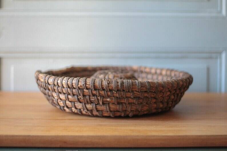 Old wicker basket, straw and bramble, woven basket, countryside, chalet, kitchen, interior decoration.