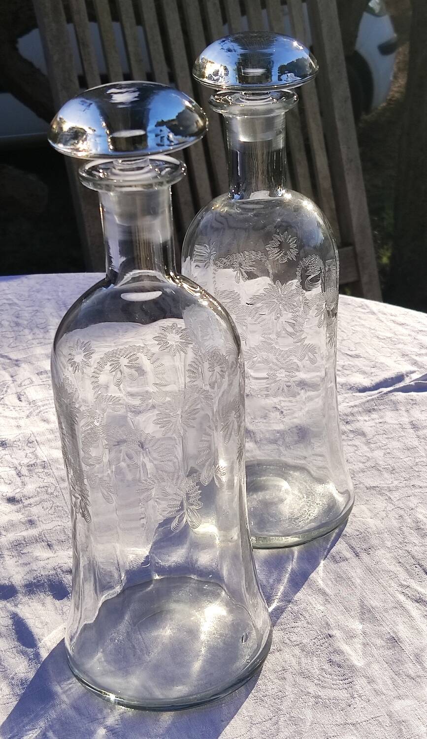 Two antique engraved glass bottles