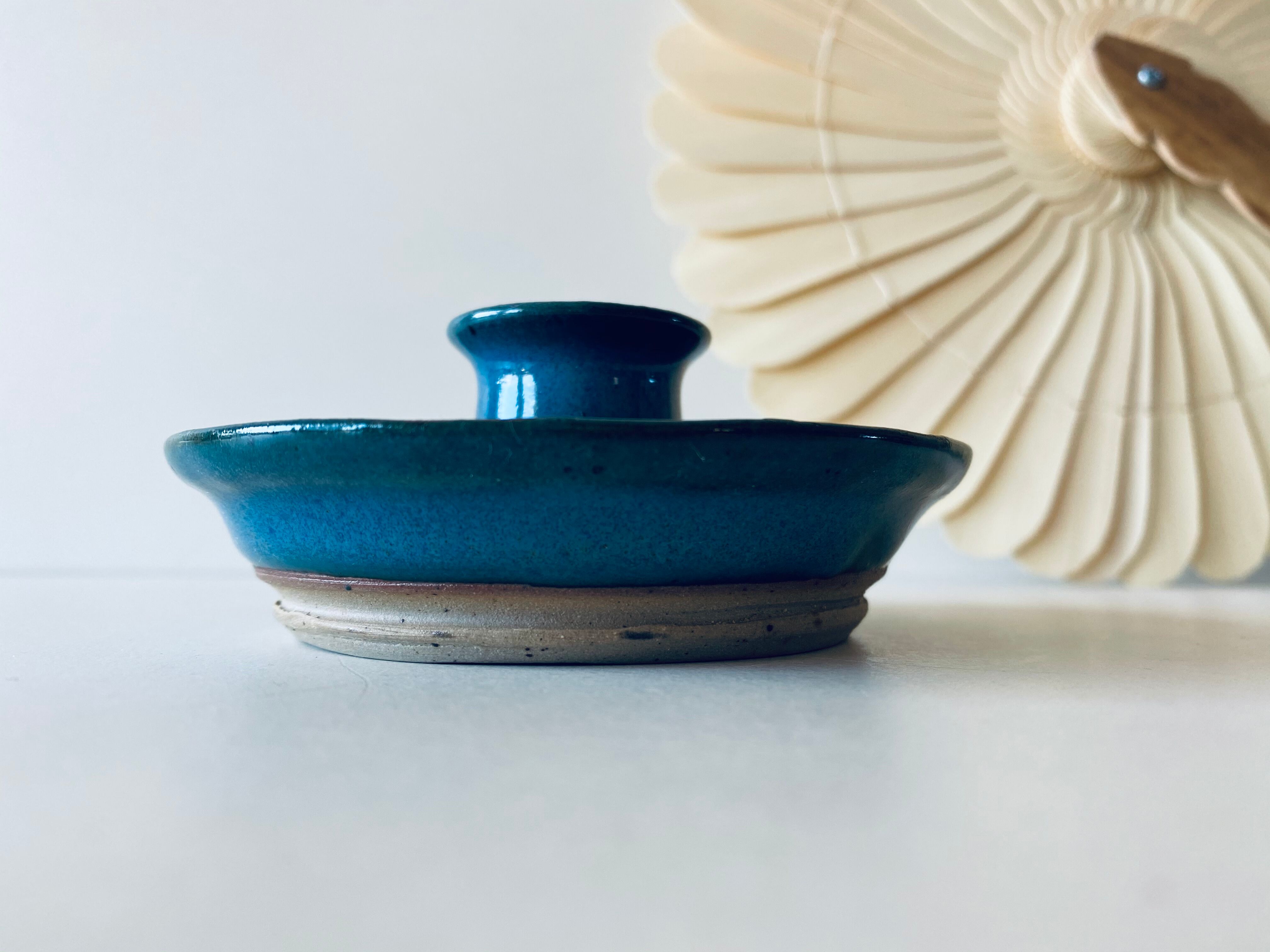 Blue enamelled sandstone candlestick