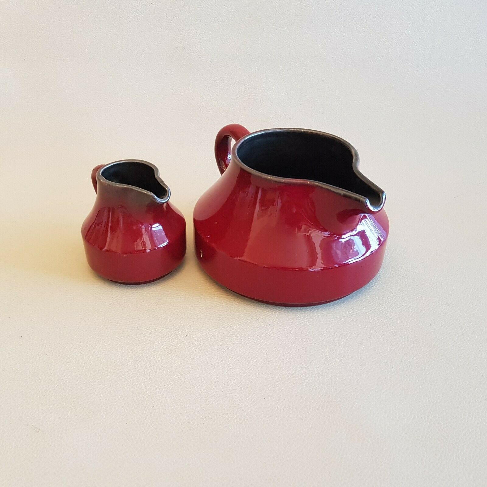 Teapot and milk jar in burgundy red ceramic