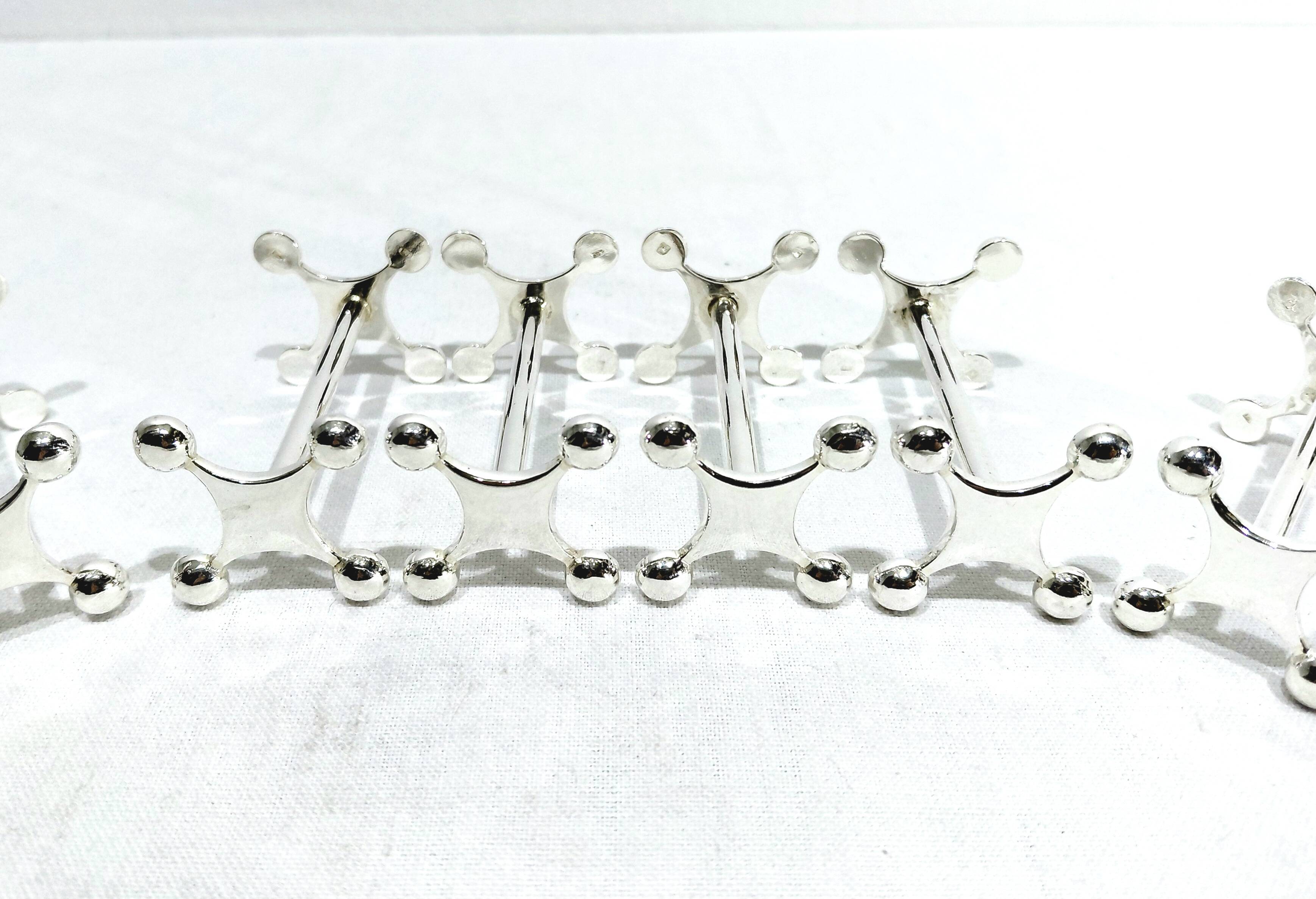SET OF 12 SILVER-PLATED KNIFE RESTS