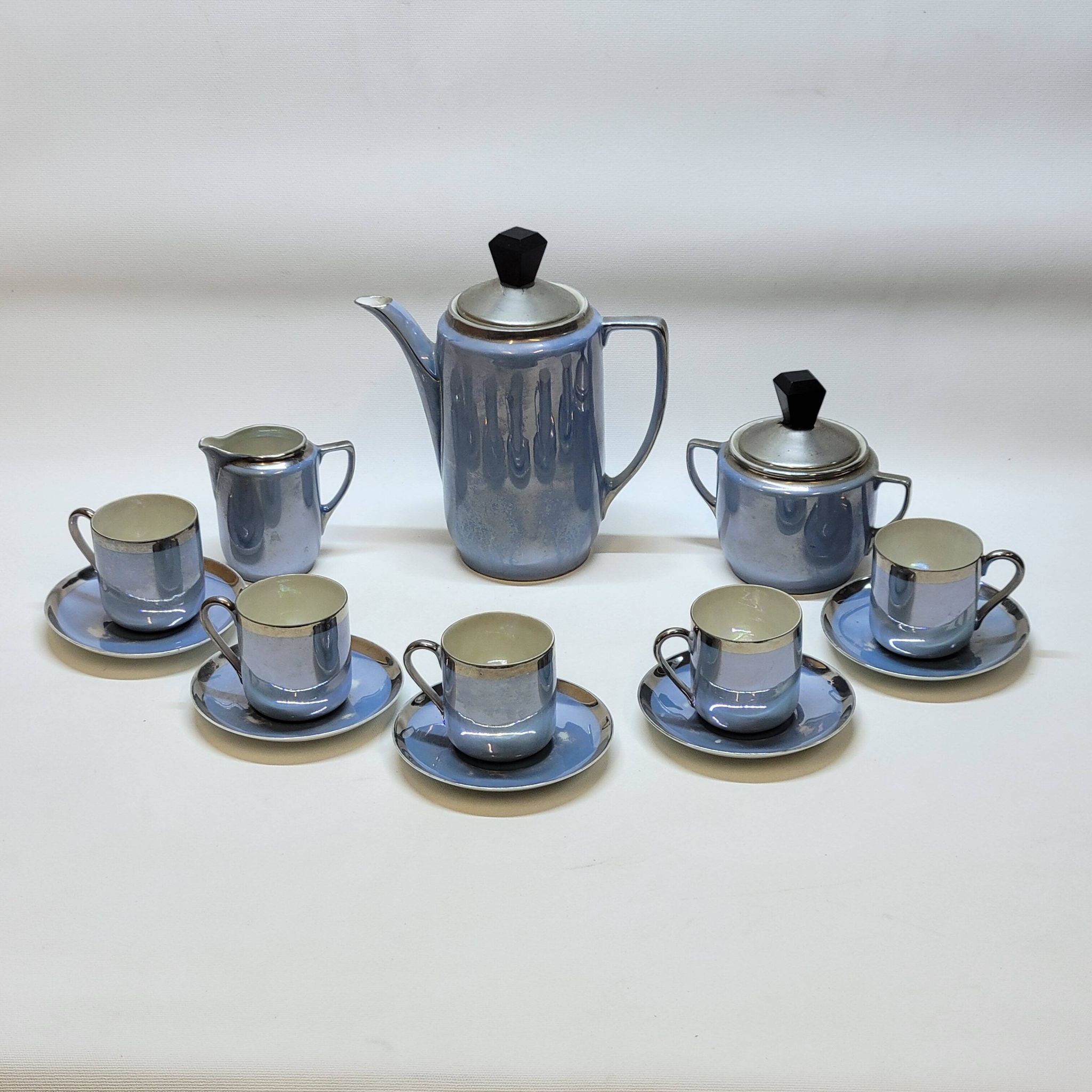 Art deco coffee service in fine iridescent blue porcelain, metal and wood