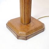 Lamp base in saddle stitched leather and raffia lampshade.