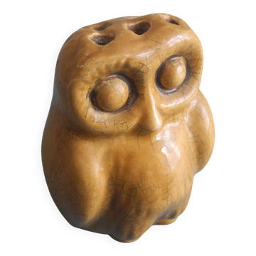 vintage earthenware vase with an old flower pick and an owl decoration