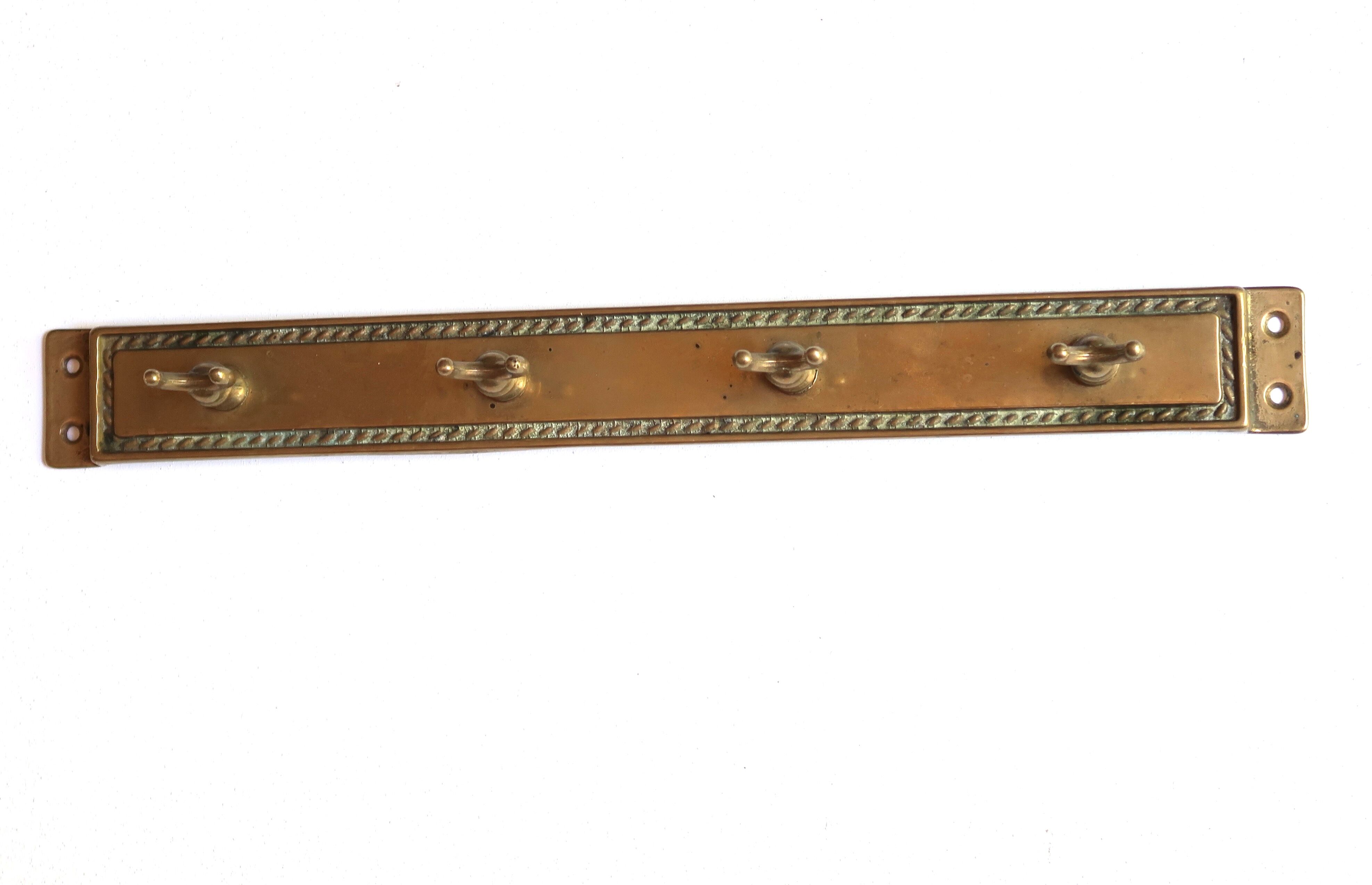 Brass and wood kitchen utensils with wall display, 60s