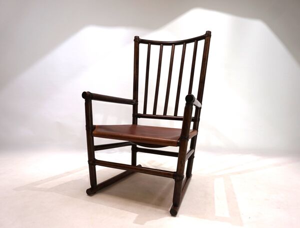 Fauteuil Manou en rotin et assise en cuir, 1960