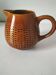 Caramel slipware pitcher with braided relief