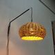 Mid-century modern Danish extendable cantilever wall lamp with a rattan shade, 1960s.