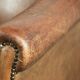 Vintage sheepskin club armchair finished with decorative nails