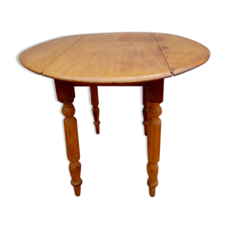 Round side table has folding wheeled honey color