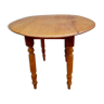 Round side table has folding wheeled honey color