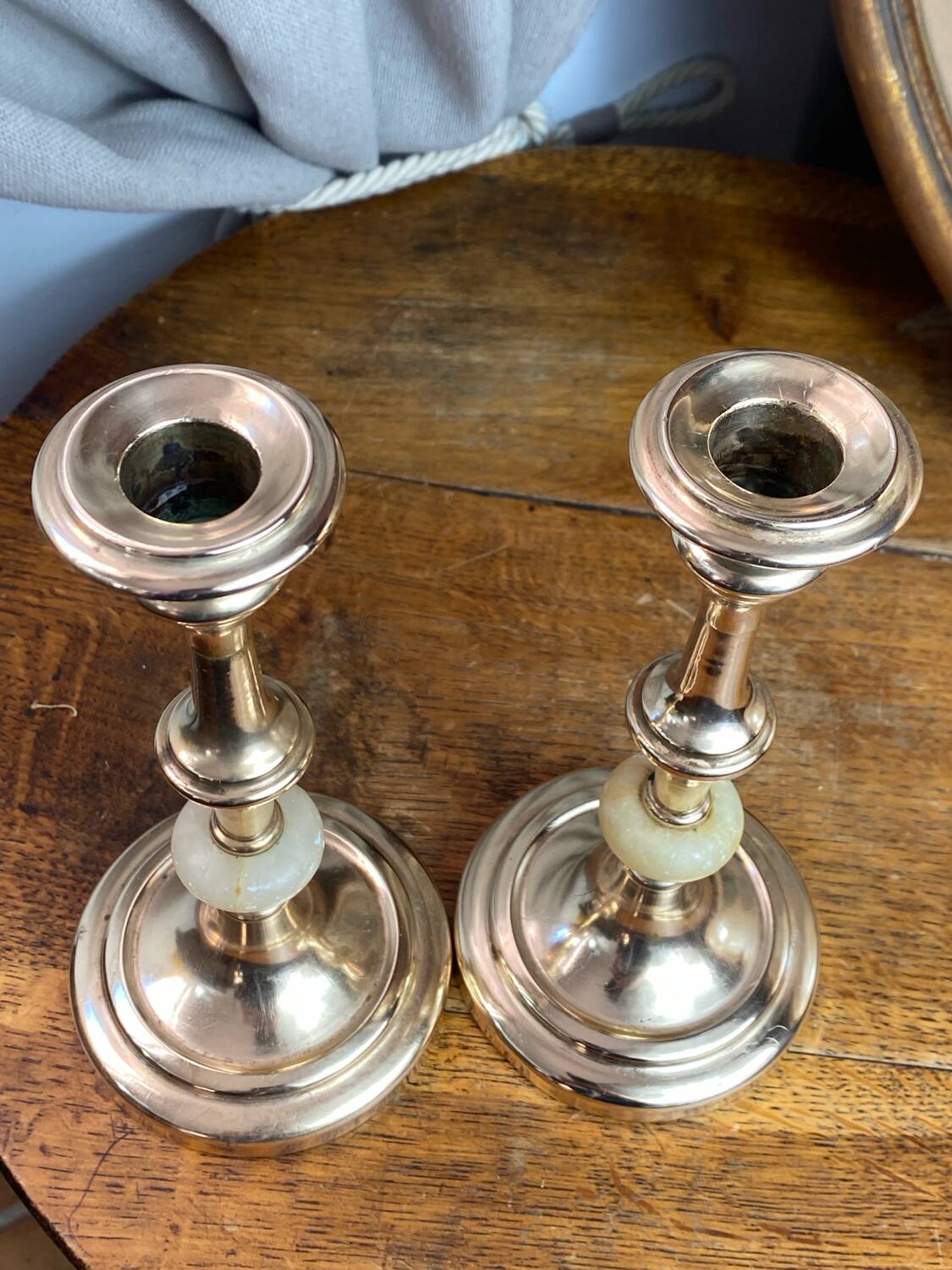 Pair of brass and stone candlesticks