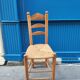 Neo-rustic chair in wood and wicker in the brutalist style by Charles Dudyoyut.