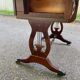 Victorian English extendable coffee table made of solid mahogany and leather.