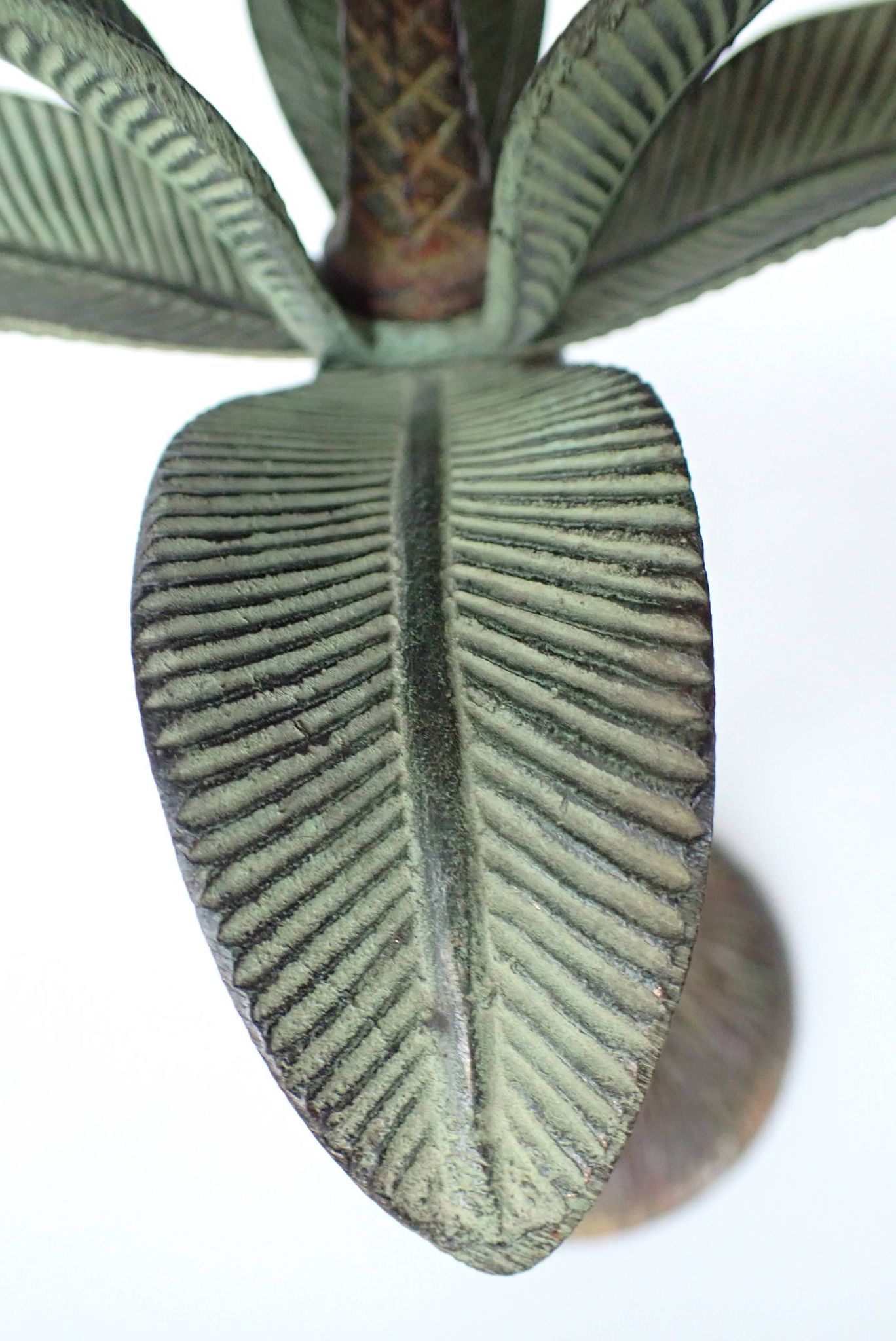Antique palm tree-shaped candlestick in patinated metal