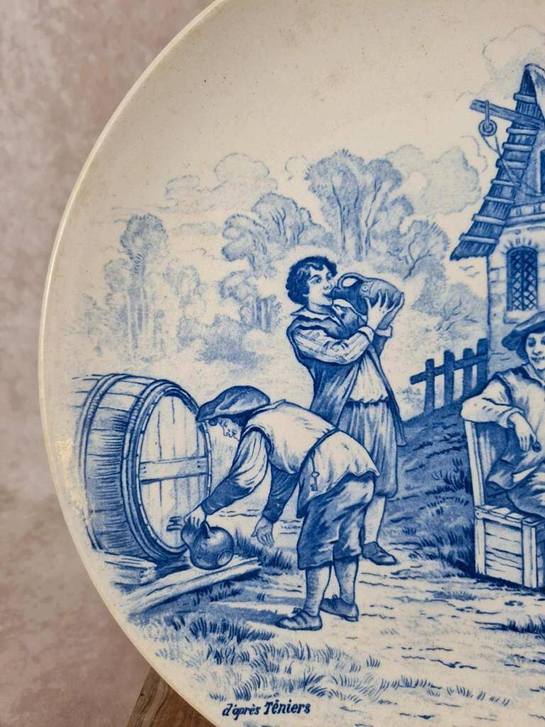 Old advertising plate with blue decoration after Teniers – 100,000 Shirts Paris