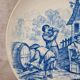 Old advertising plate with blue decoration after Teniers – 100,000 Shirts Paris