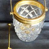 Glass and gold metal ice bucket with its gold metal spoon.