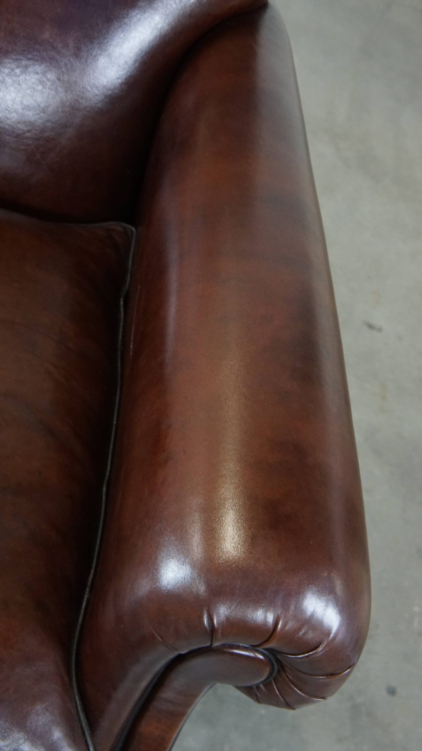 Comfortable and correct dark antique sheepskin English armchair in very good condition