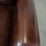 Comfortable and correct dark antique sheepskin English armchair in very good condition