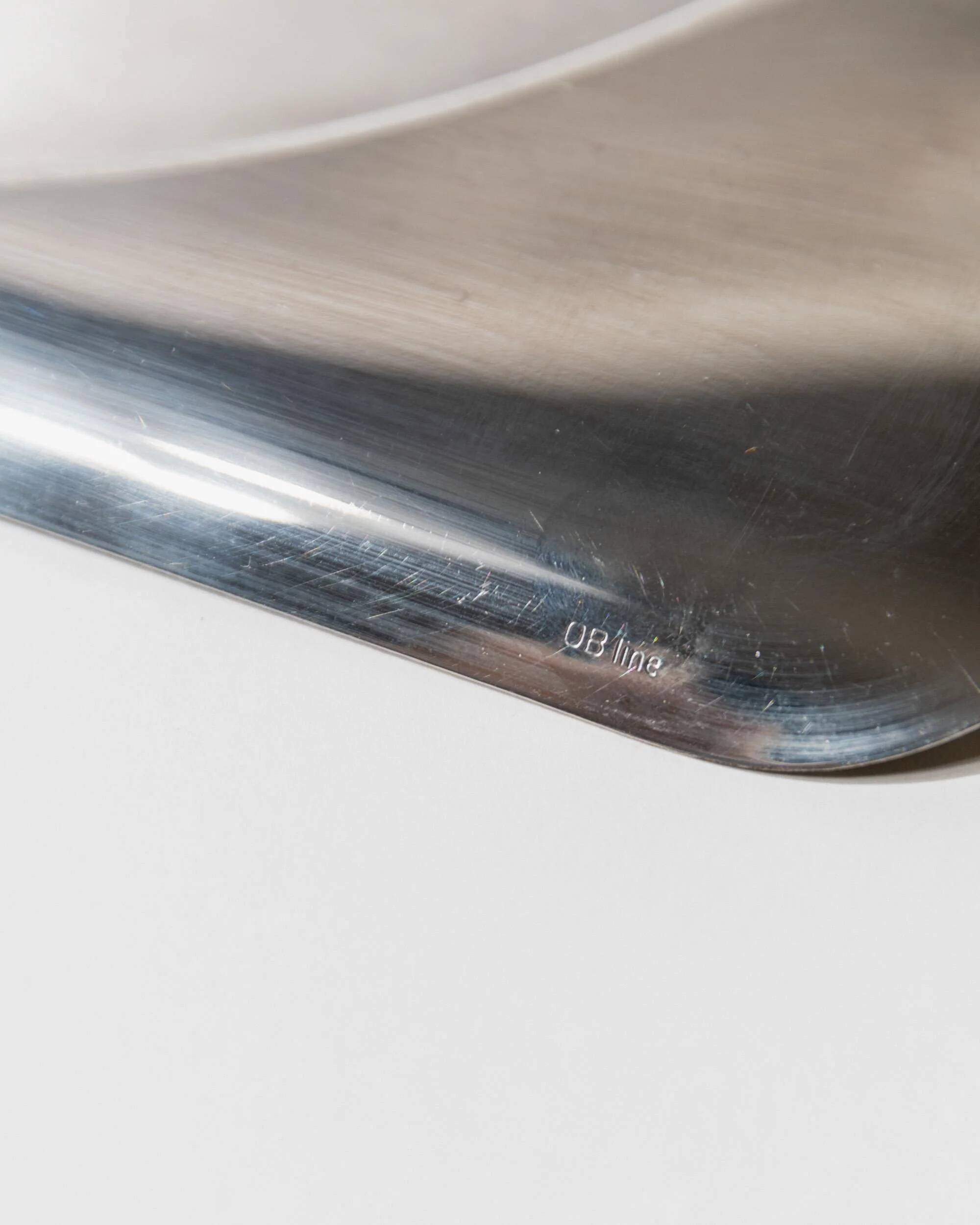 1990s vintage stainless steel platter, rectangular with an oval indentation, minimalist modern design.