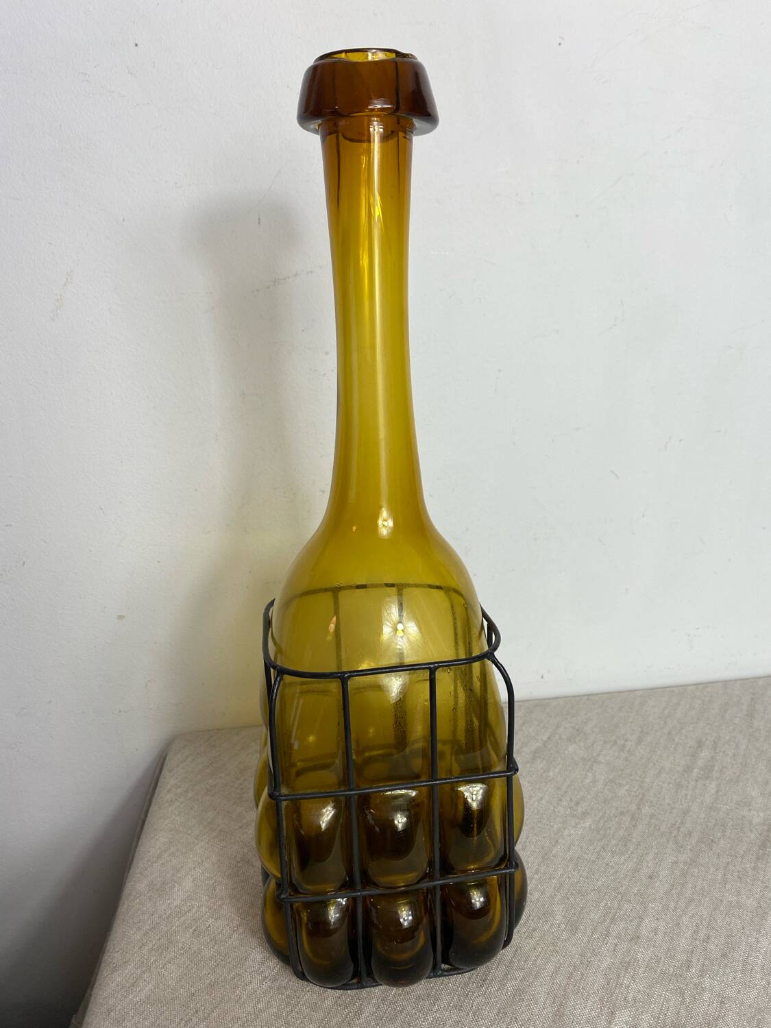 Glass carafe encased in wrought iron