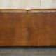 Three-seater Art Deco style leather sofa with feather cushions.