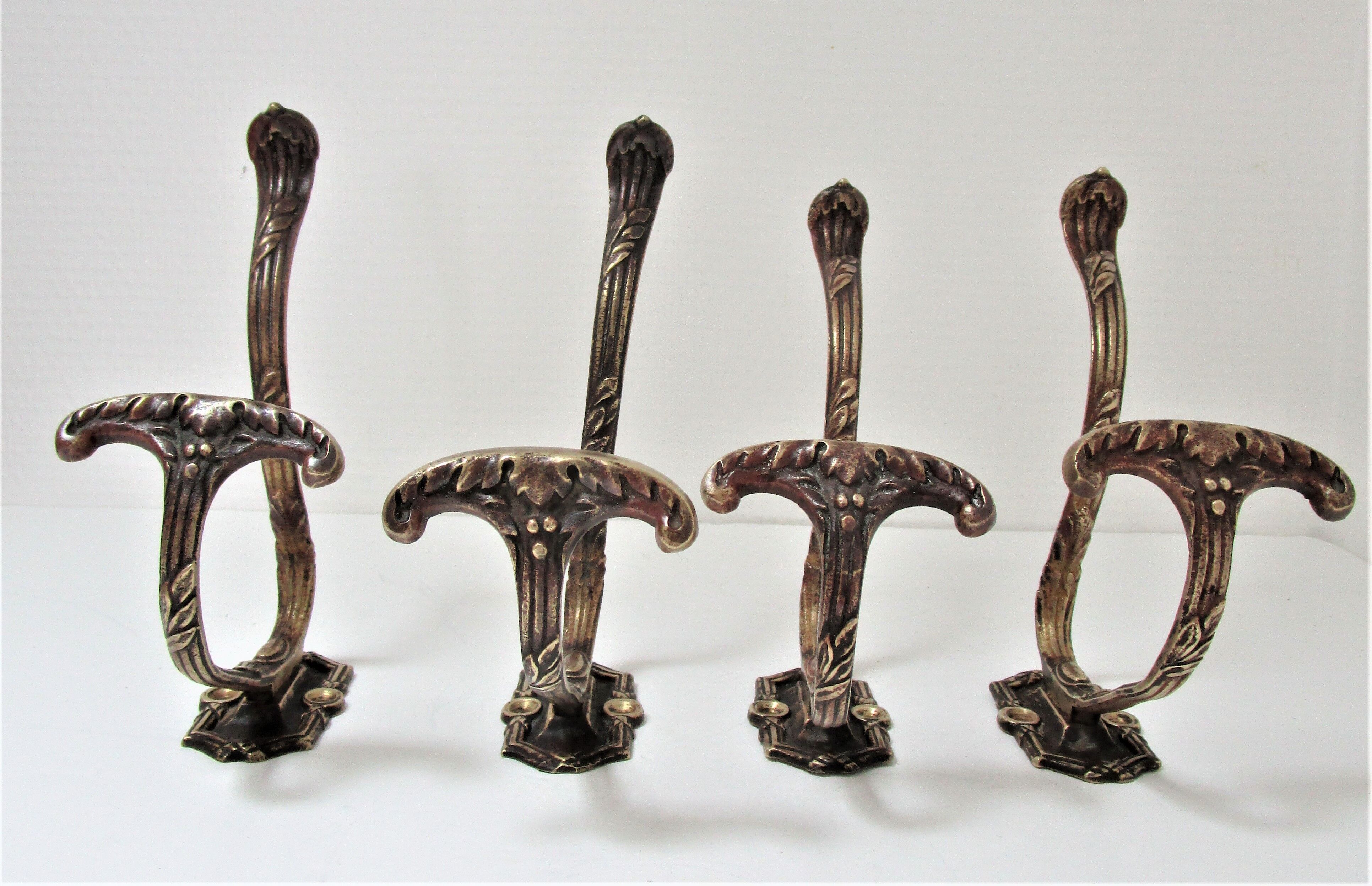 Four patères bronze patinated leafy décor early 20th century