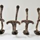 Four patères bronze patinated leafy décor early 20th century