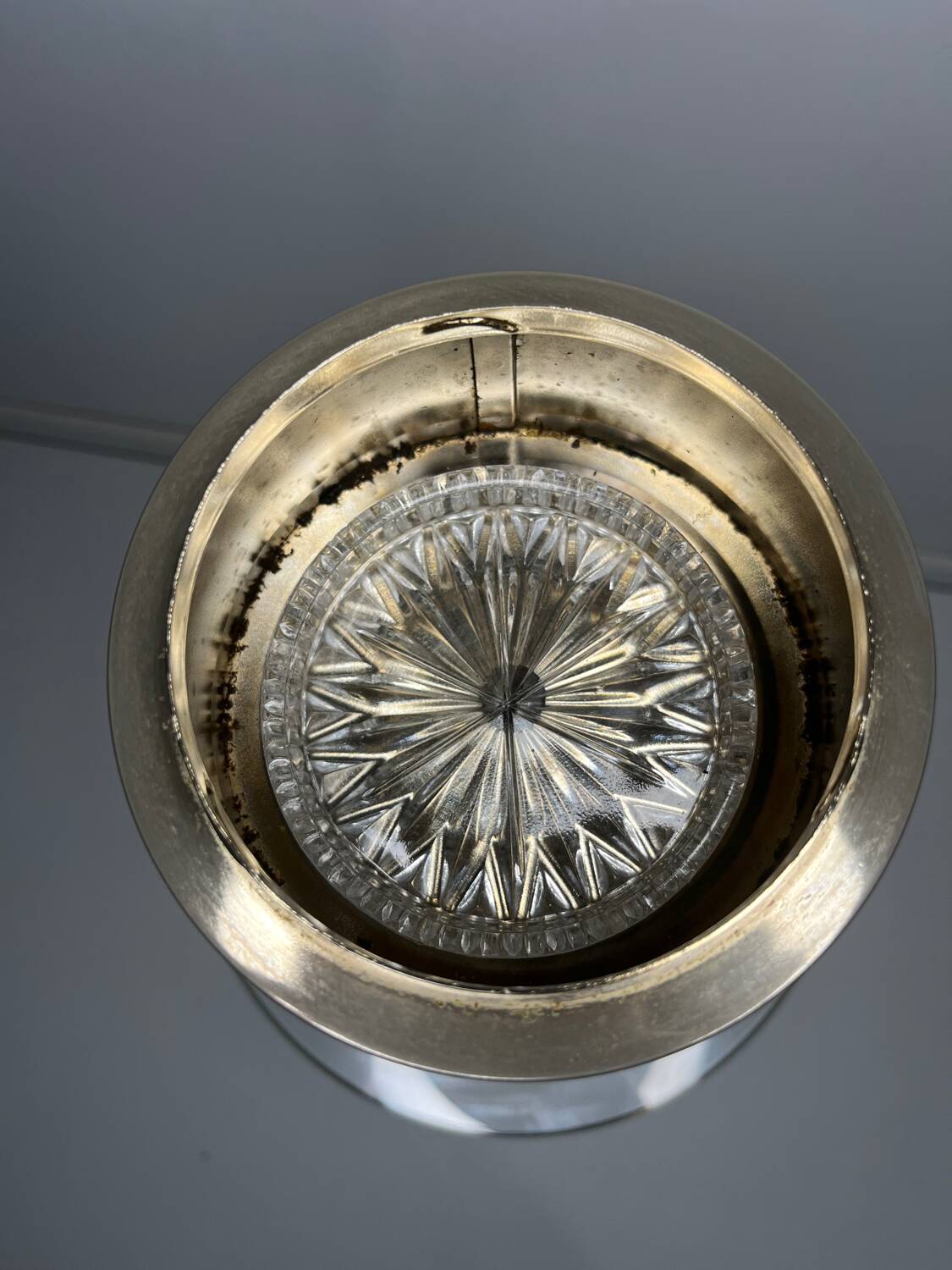 Vintage brass floor ashtray with glass shelf in Empire style.