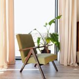 Vintage armchair in moss green bouclé design by H. Lis.