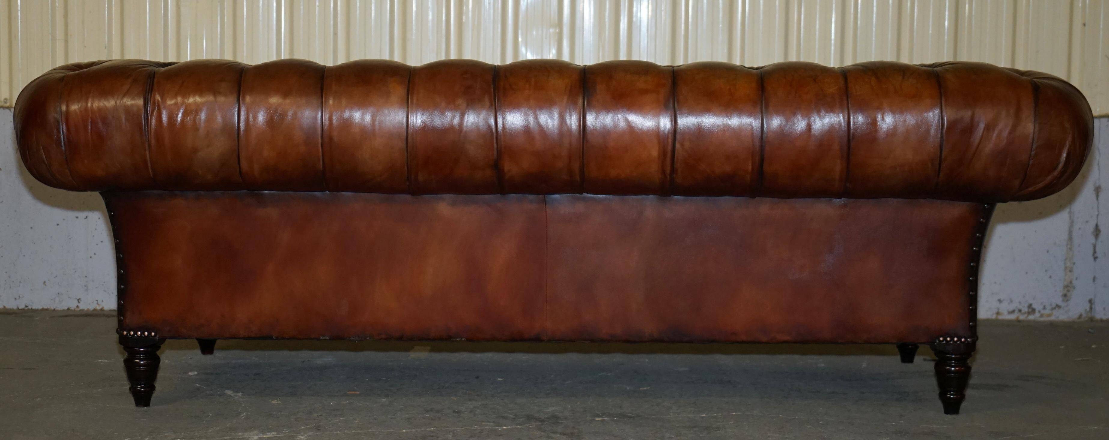 Pair of Early Victorian leather Chesterfield sofas by George Smith.