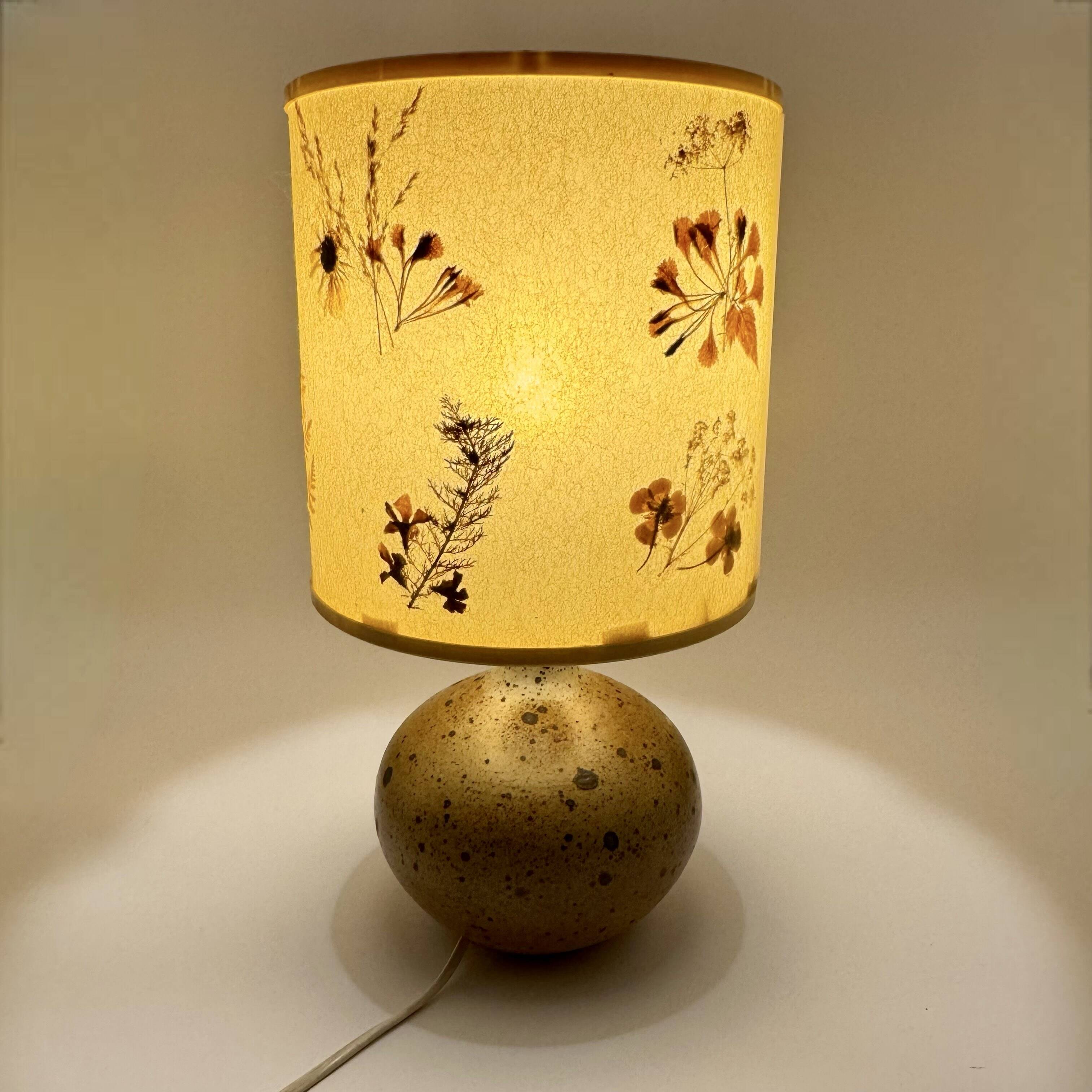 Pyrite stone ball lamp with a lampshade featuring dried flower inclusions.