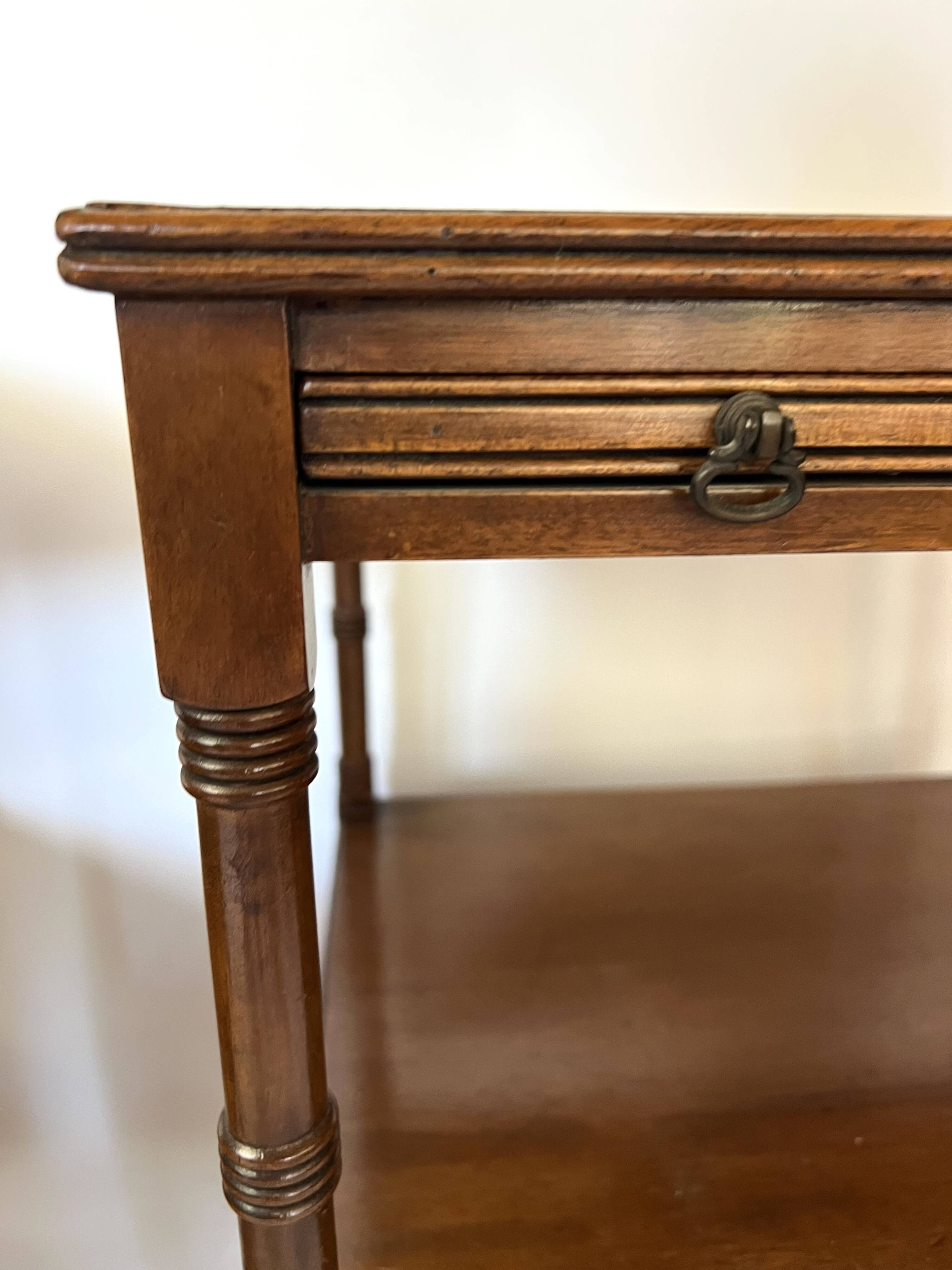 Pair of English mahogany side tables with sliding shelf.