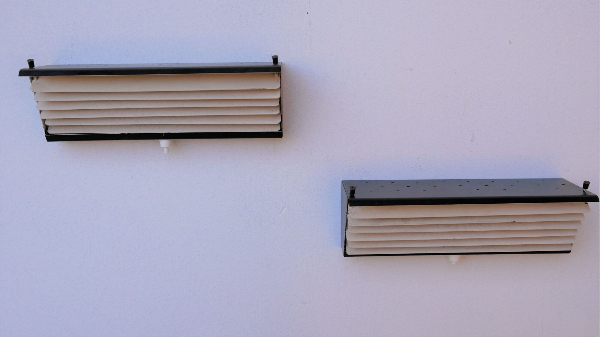 Pair of modernist metal wall light model 212, by Jacques Biny for Luminalite