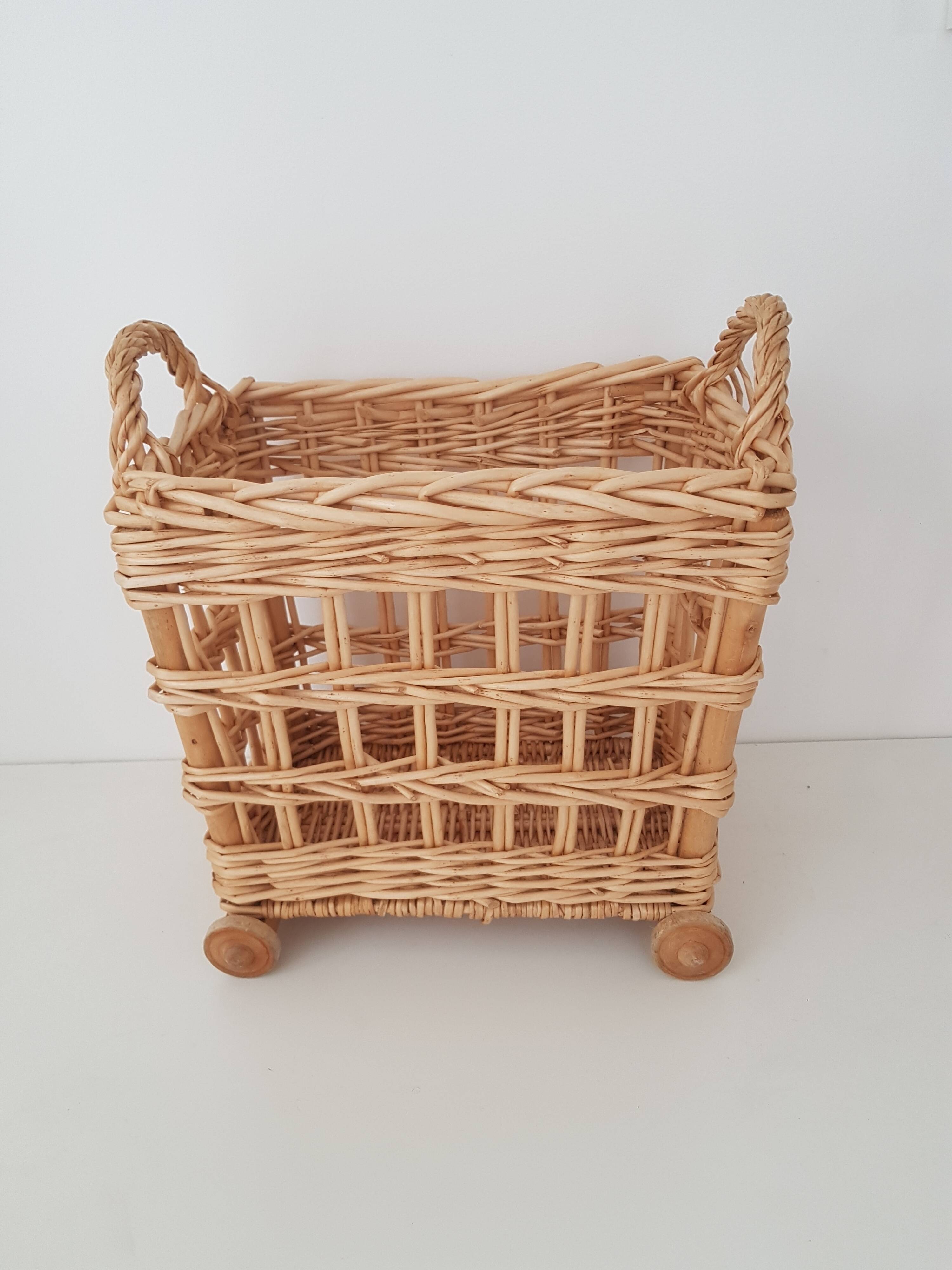 Vintage wicker basket on wheels - children's toy trolley