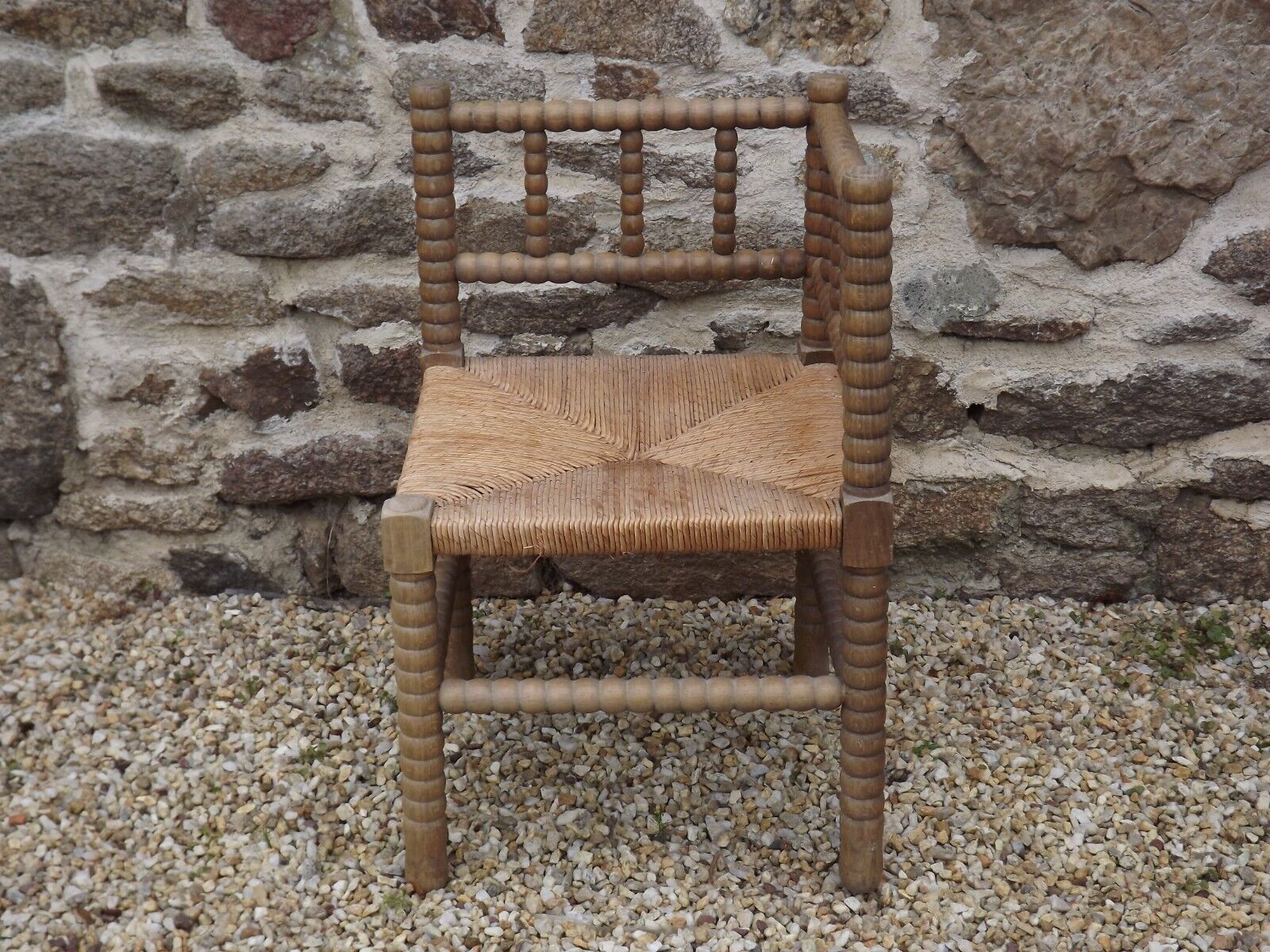 French antique turned wooden bobbin chair with rush seat