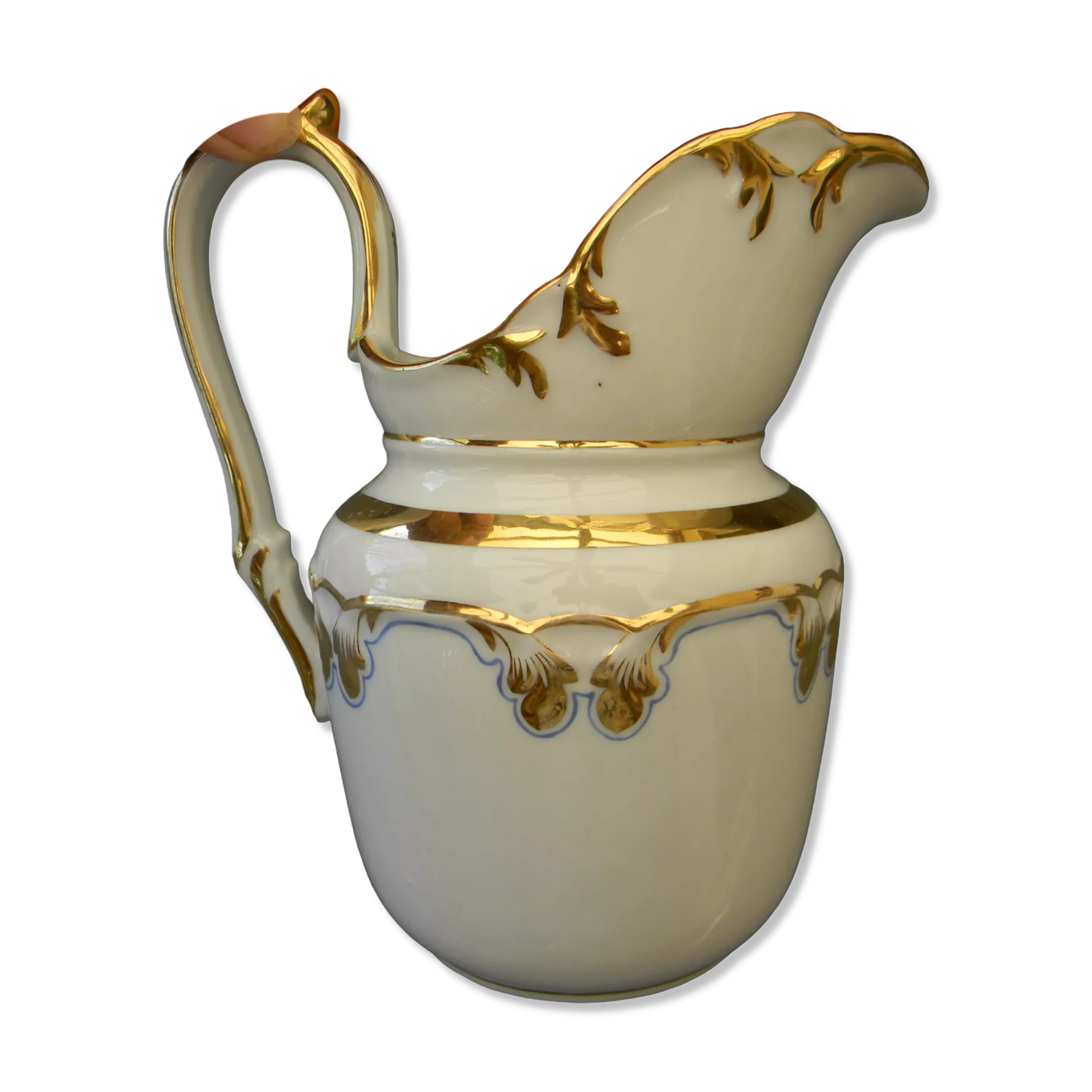 Milk jug or antique pitcher in white and gold porcelain.