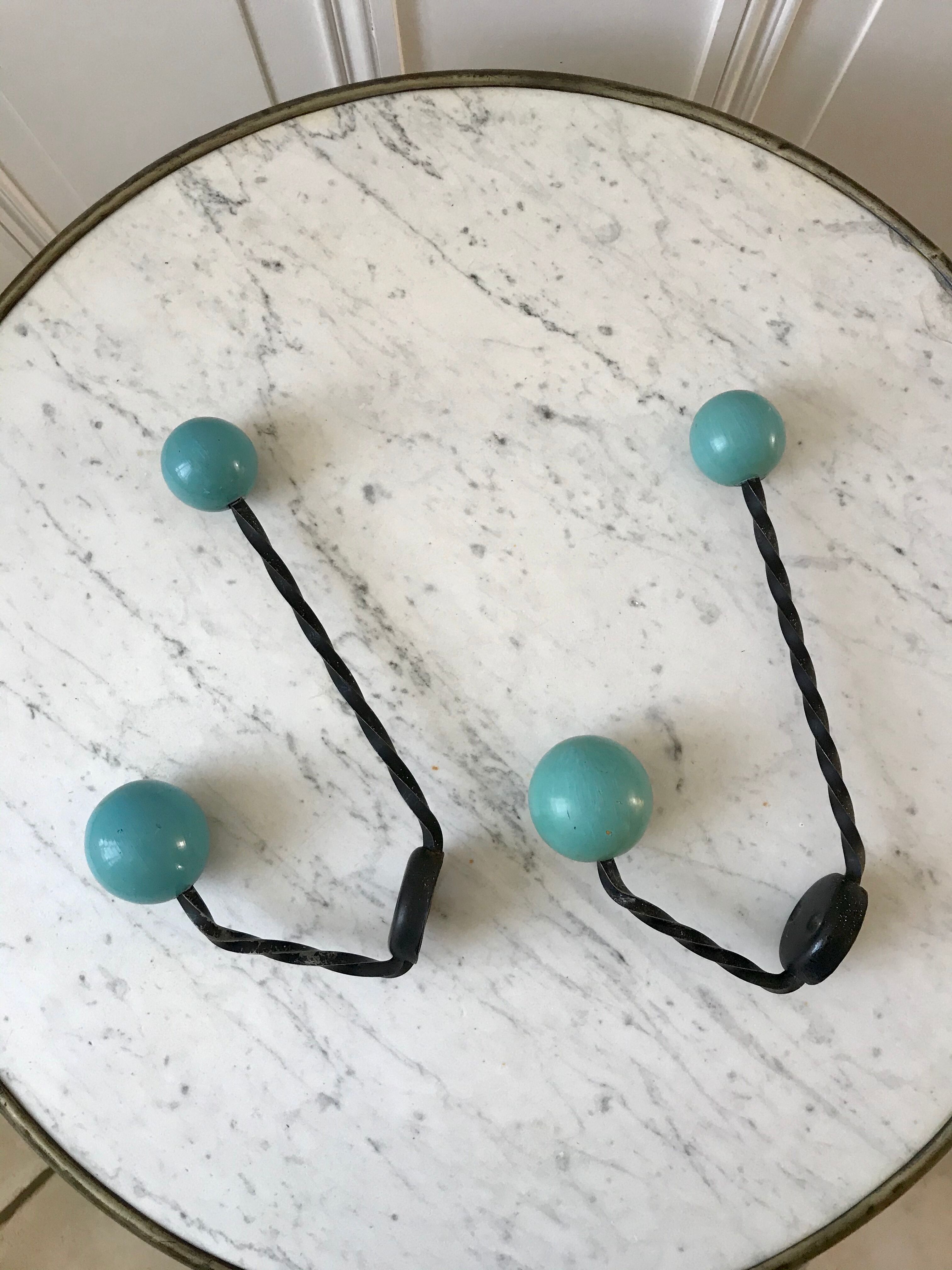 Duo of hooks balls in blue wood and black iron 60s