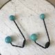 Duo of hooks balls in blue wood and black iron 60s