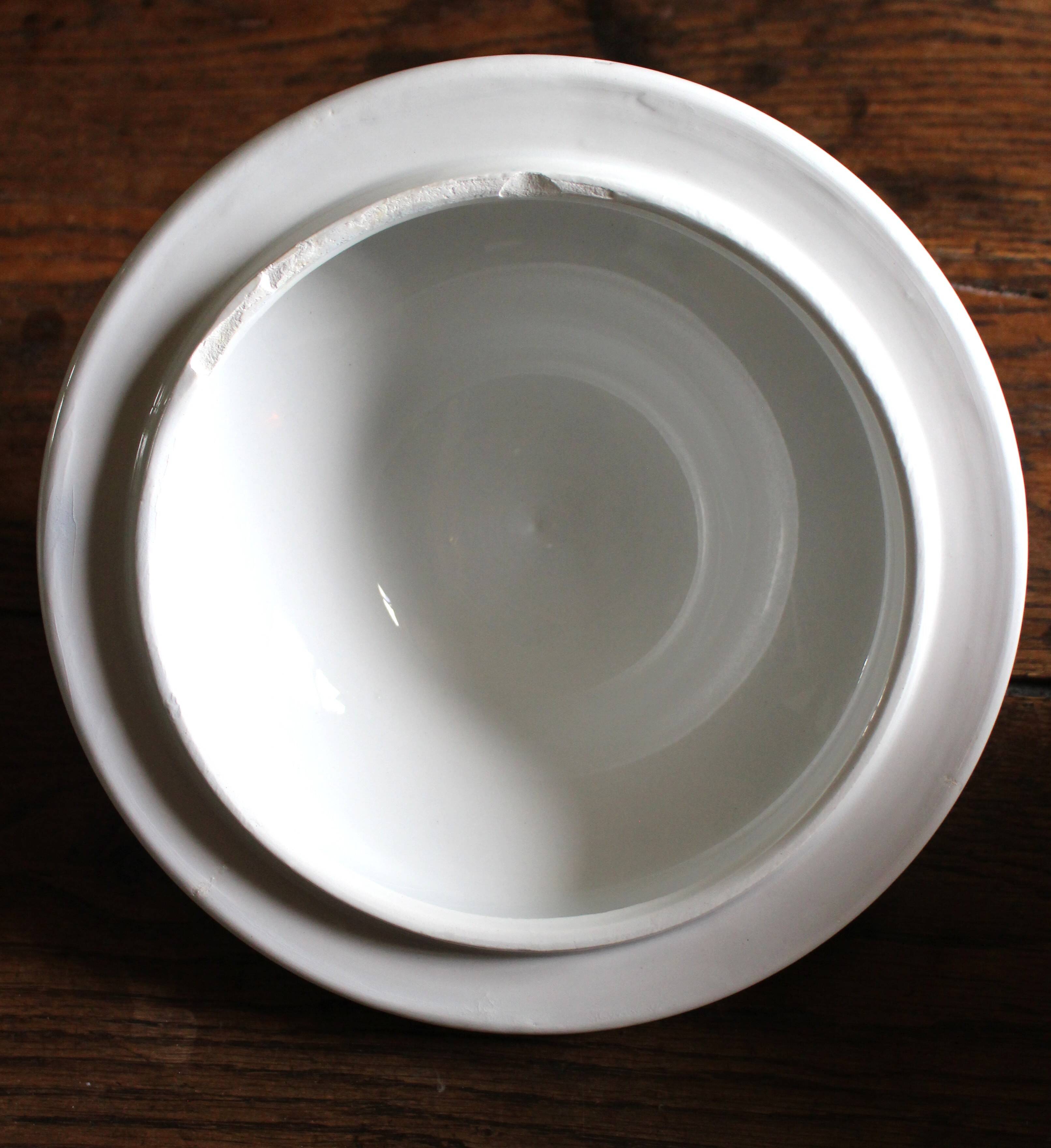 Antique soup tureen, white earthenware, with stopper decoration.