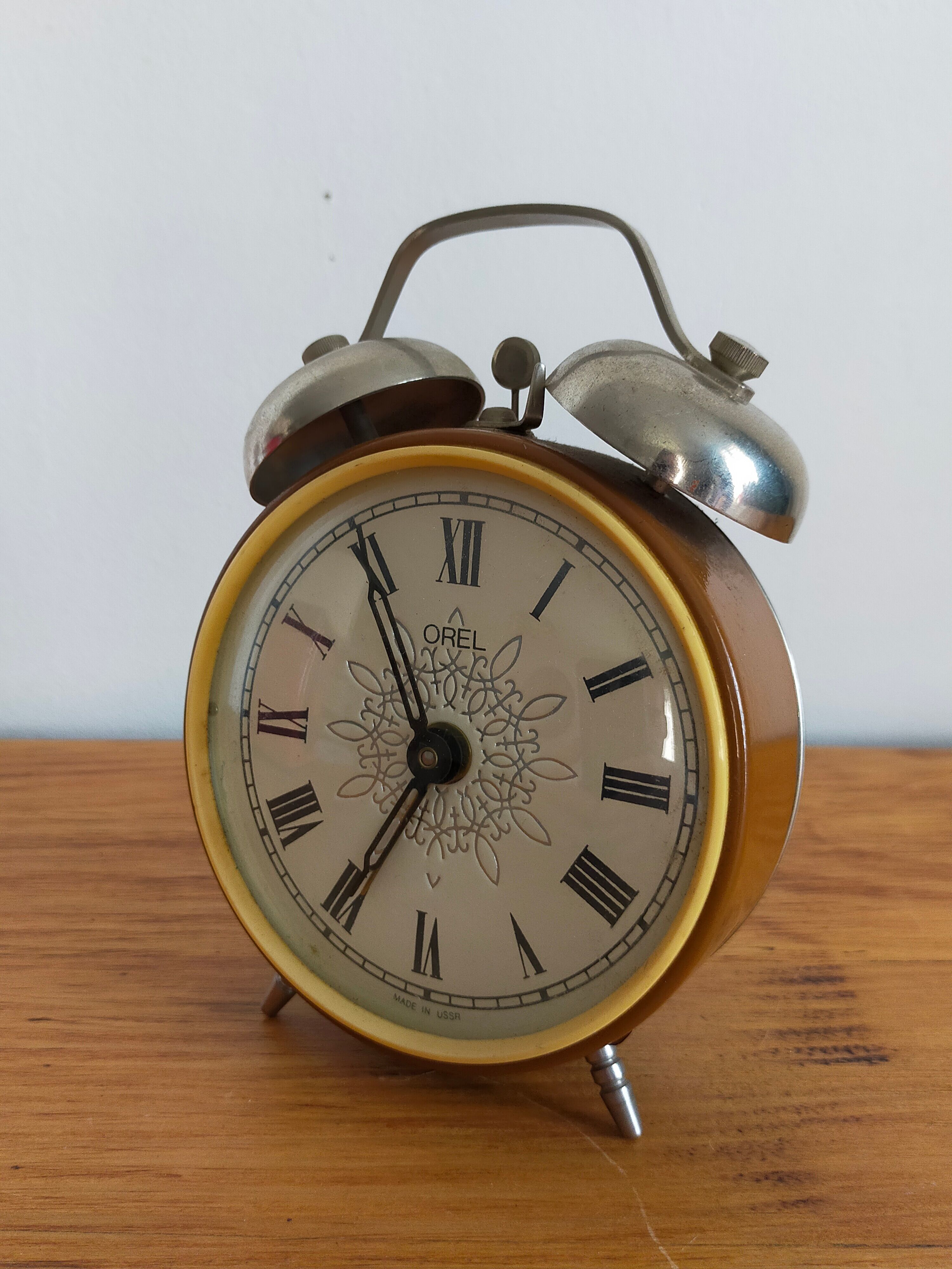 Vintage brown and silver mechanical alarm clock