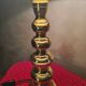 This elegant table lamp features a sculptural base in shiny gold brass.