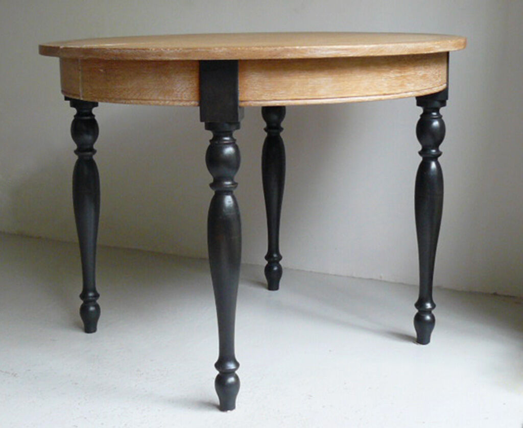 Round table in coloured cerused oak, waxed coloured feet