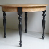 Round table in coloured cerused oak, waxed coloured feet