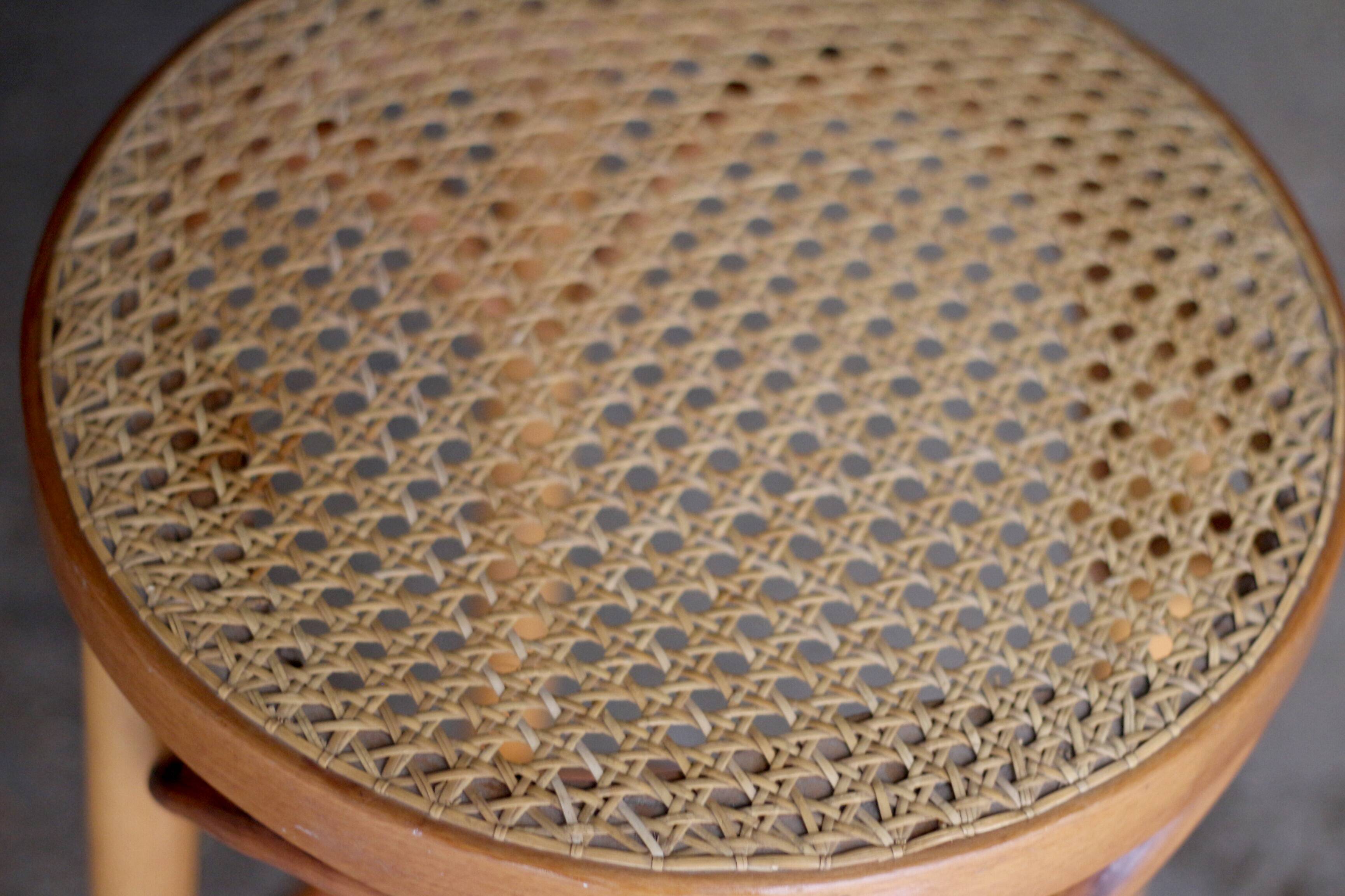 Beautiful caned stool in curved blond wood. 1940s/1950s