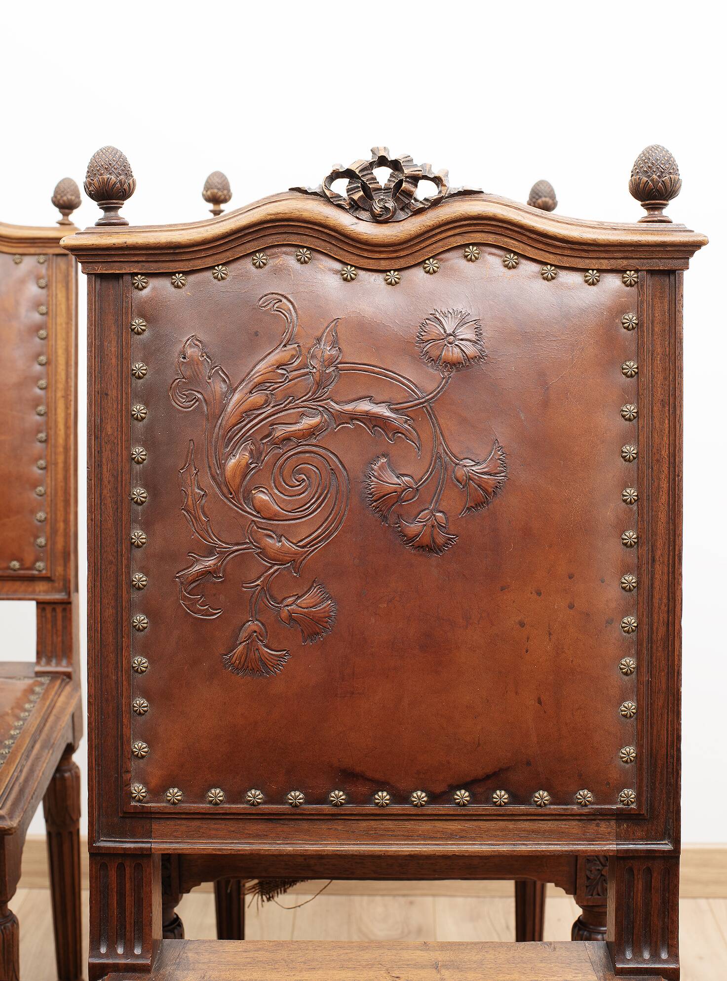 Set of 4 Louis XVI style chairs in carved wood and embossed leather.