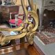 Mirror with carved and gilded wooden frame, 18th century, with scrollwork decoration.