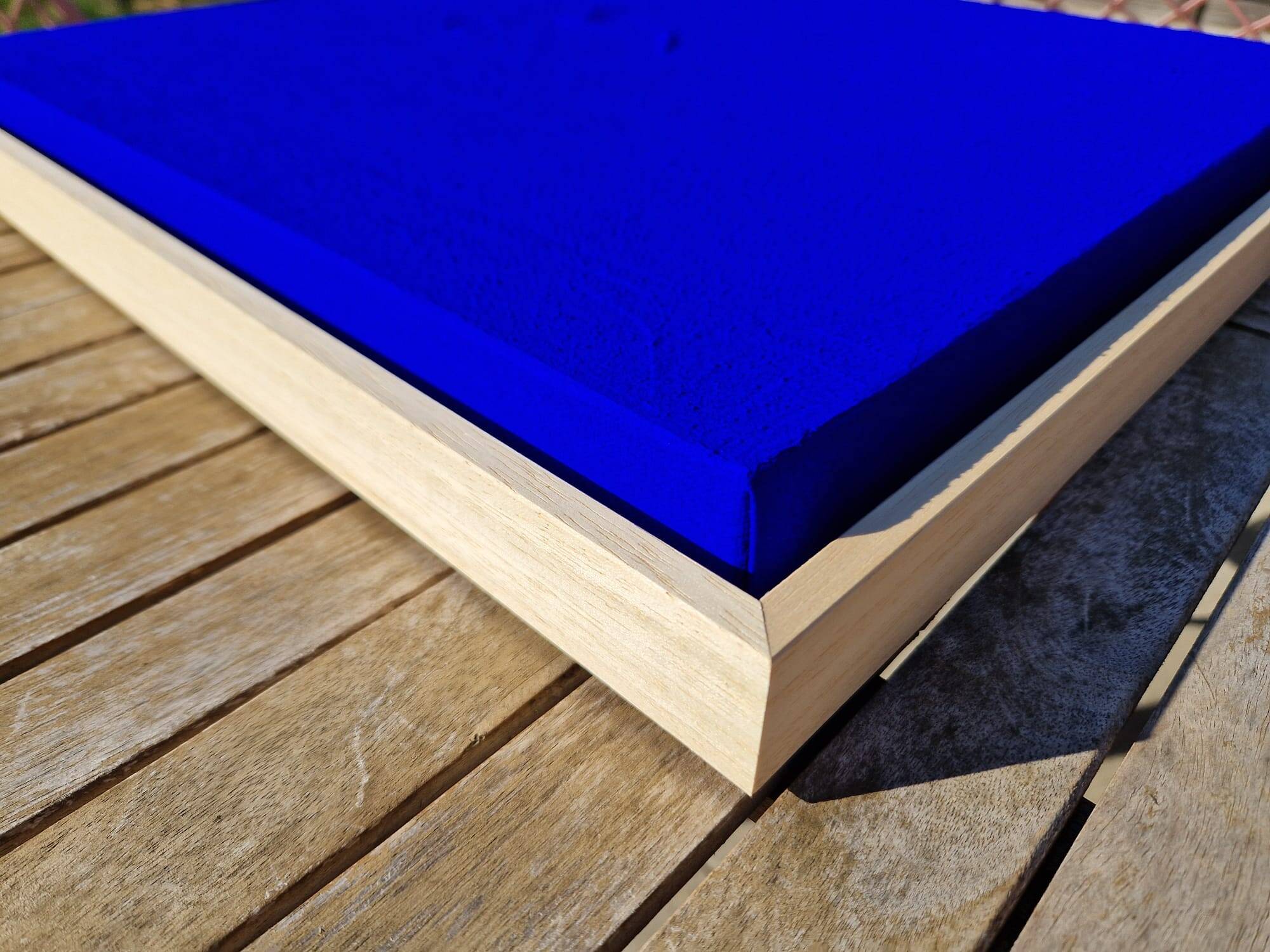 Framed monochrome blue abstract painting.